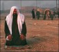 A man offers a prayer at the street