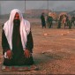 A man offers a prayer at the street