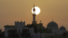 Sun rises behind a minaret on Abu Dhabi- Dubai highway, United Arab Emirates, Sunday Nov. 6, 2011. Muslims celebrate Eid Al-Adha Sunday. (AP Photo/Kamran Jebreili)